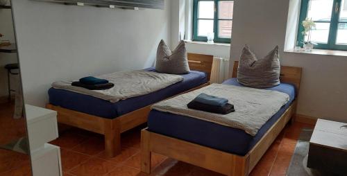 a room with two beds with pillows on them at Lunitz 19 in Görlitz