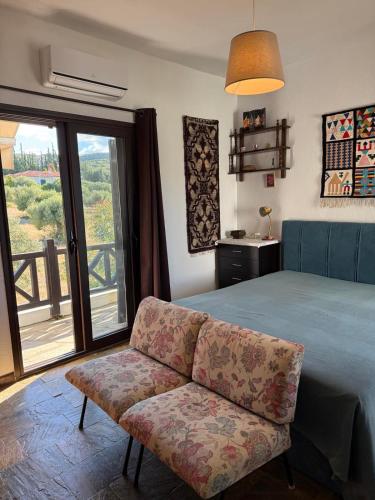 a bedroom with a bed and a couch and a window at Elia Sea View Apartments 2 in Elia