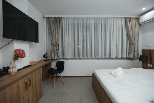 TV a/nebo společenská místnost v ubytování Hotel Riverside