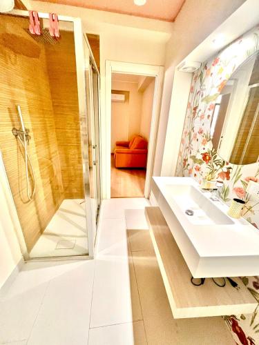 a bathroom with a sink and a shower at Doria Suite in Patti