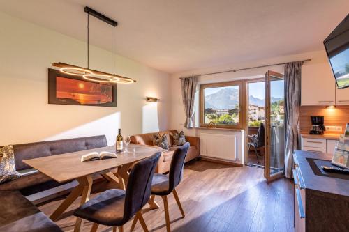 a living room with a table and a couch at Ferienhof Hubertus in Mayrhofen