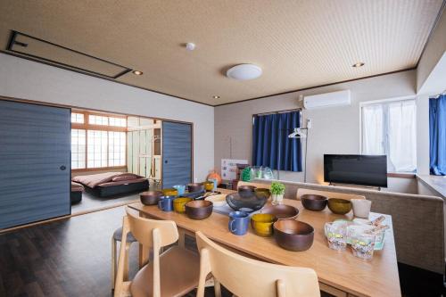 a living room with a wooden table and chairs at kuki 67ｍ2 Modern Japanese style Toys for kids 2Bedroom in Kuki