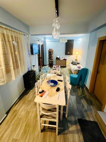 a room with a table and chairs and a living room at Villa Christoforos Kekakos Magical View in Neapolis