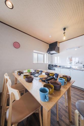 a kitchen with a wooden table with bowls on it at kuki 67ｍ2 Modern Japanese style Toys for kids 2Bedroom in Kuki