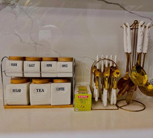 a shelf with a bunch of towels and kitchen utensils at Skyline Hotel Apartments-Elysium Tower Facing Centaurus Mall Islamabad in Islamabad
