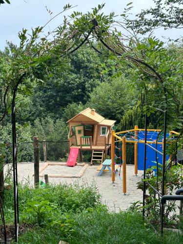 a playground with a play set and a house at Private Luxury Spa & Silence Retreat with Spectacular View over the Lake Maggiore in Stresa