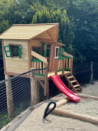 a play set with a slide and a house at Private Luxury Spa & Silence Retreat with Spectacular View over the Lake Maggiore in Stresa