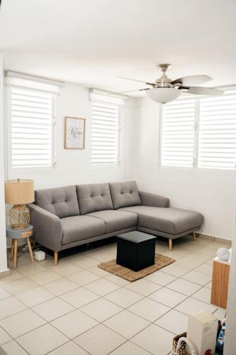 a living room with a couch and a table at La Vecchia Village Spacious Private Pool Area in Guayama