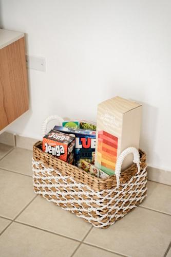 a basket full of books on the floor in a kitchen at La Vecchia Village Spacious Private Pool Area in Guayama
