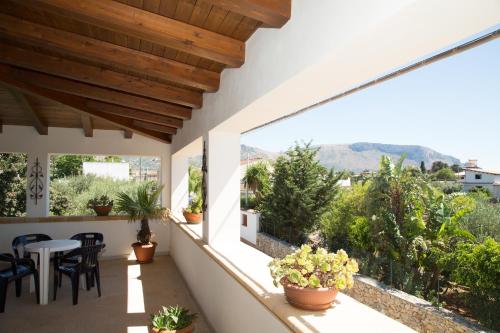 a balcony with a table and chairs and plants at Le Terrazze Di Don Mariano in Cinisi
