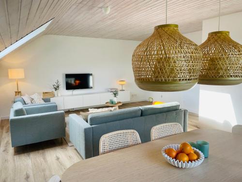 una sala de estar con una mesa con naranjas. en Urlaub in der Eifel am Rursee - Wita31, en Einruhr