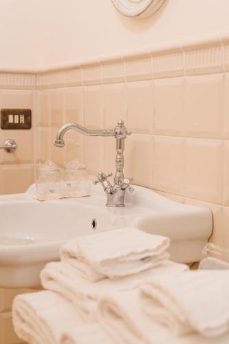 a bathroom with a sink and a faucet at Villa Nena in Tolentino