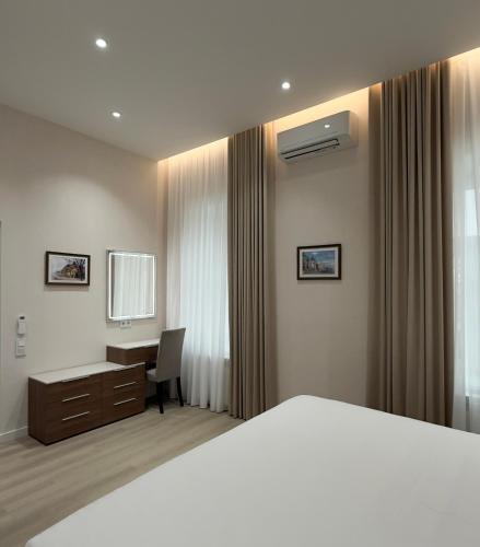 a hotel room with a bed and a desk at MK Luxury Serviced Residences #3 in Chişinău