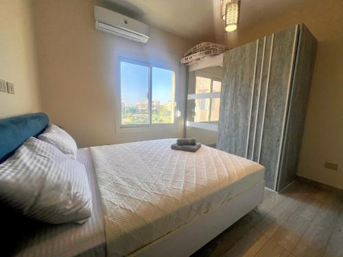 a bedroom with a large bed and a window at 3-Brs Beachside Modern chalet Seaview & 3min walking l BBQ in Ain Sokhna