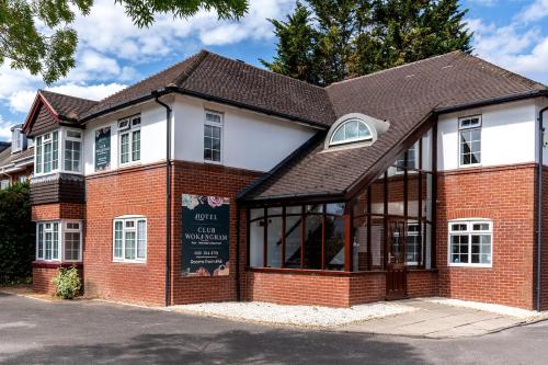 a brick building with a sign in front of it at Club Wokingham Hotel in Wokingham