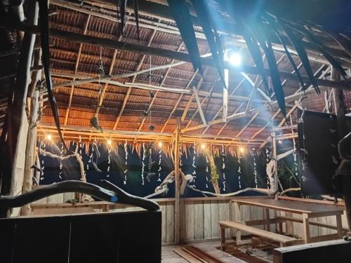 a large room with a ceiling with a large animal skeleton at Naviza Homestay in Kepulauan Fam