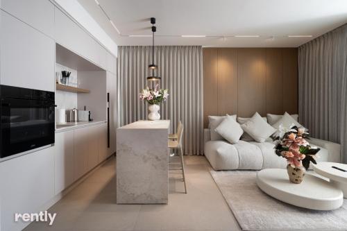 a living room with a couch and a table at Eilat 42-by rently in Eilat