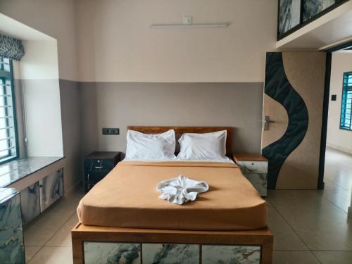 a bedroom with a bed with a bow on it at Misty cloud homestay in Pīrmed