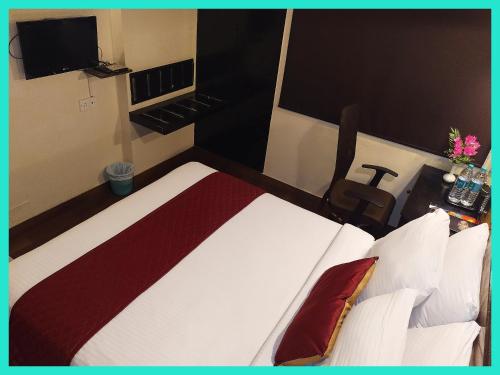 a hotel room with a bed and a television at HOTEL -THE R & HS PALACE - Near Sea Beach - Shree Jagarnath Temple - Free Wi-Fi Facilities # Fully Air Conditioned Hotel At Prime Location in Puri