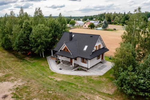 an overhead view of a house with a black roof at Rodzinne wczasy nad Czarną Hańczą 