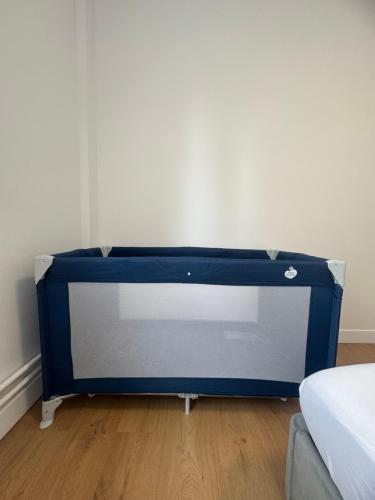 a large blue tv in a room with a couch at Le 9 - Basel Airport in Saint-Louis