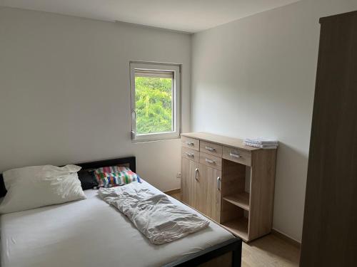 a small bedroom with a bed and a window at Zöldkert Kecskemét in Kecskemét