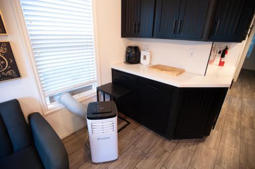 a kitchen with a trash can next to a counter at Tiny Blue at Yosemite Gateway in Groveland