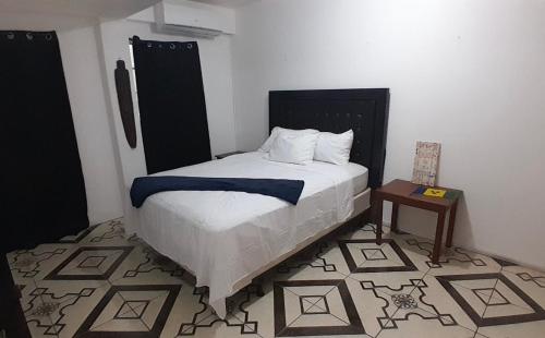 a bedroom with a bed and a table in it at 5 mins walk from Kingstown! - McKies Hill Suite #1 - Your Home Away from Home in Kingstown