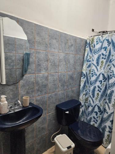 a bathroom with a blue sink and a toilet at Townhouse in Siguatepeque