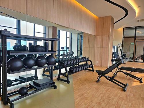 a gym with a row of exercise equipment in a room at Vortex Residenc klcc serviced apartment near by Bukit Bintang in Kuala Lumpur
