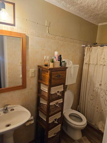 a bathroom with a toilet and a sink at Casa equipada y acogedora in Trinidad