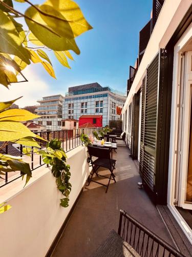 a balcony with a table and chairs on a building at Living Funchal Executive in Funchal