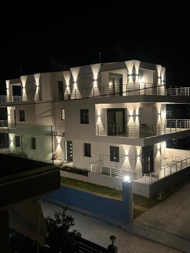 a large white building with lights on it at night at H residence 2 in Artemida