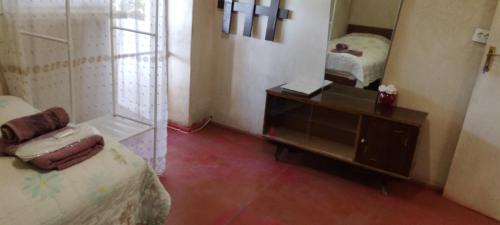 a room with a bed and a dresser and a mirror at Shushan GUEST HOUSE in Yeghegnadzor