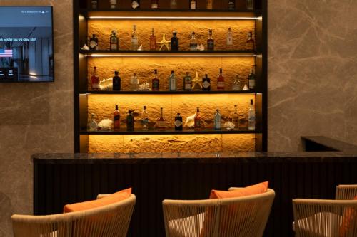 a bar with a display of bottles of alcohol at Iconique Hotel Nha Trang in Nha Trang