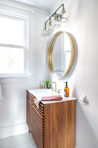a bathroom with a sink and a mirror at Prime Location Top Rated Clean Parking Free! in Columbus