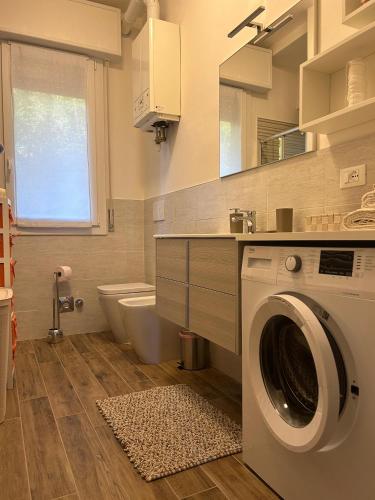 a bathroom with a washing machine and a sink at Residence Pineta in Loiano