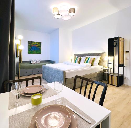 a hotel room with a bed and a table and chairs at Villa Romana Apartments with Terrace & Private Entrance in Baden
