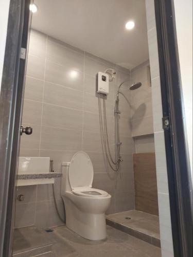 a bathroom with a toilet and a shower at Virgin River Resort Villas in Bolinao