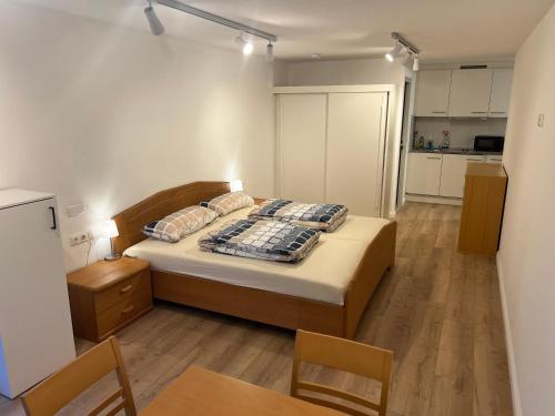 a bedroom with a bed and a table and chairs at Mellau Appartments 220 in Mellau