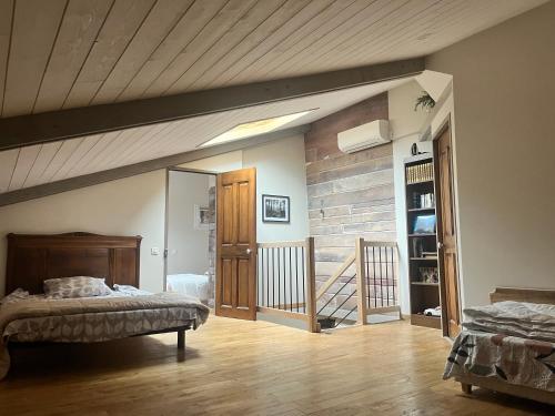 a bedroom with a bed and a wooden ceiling at Le Buis in Brette