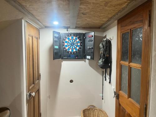 a room with a dart board on the wall at Le Buis in Brette