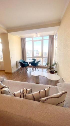 a living room with a couch and a table at Затишна красива студія в новобудові з балконом in Chernivtsi