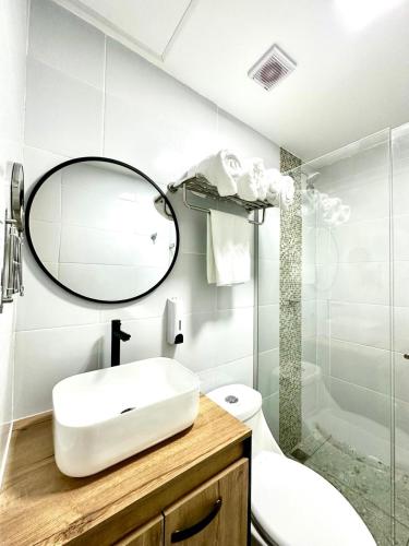 a bathroom with a sink and a mirror and a toilet at Hotel Boutique Casa Berastegui in Puerto Colombia