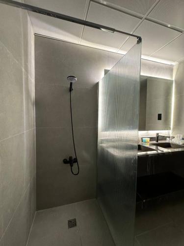 a shower in a bathroom with a stainless steel wall at برج داماك الكورنيش جدة - Damac Tower Corniche Jeddah in Jeddah