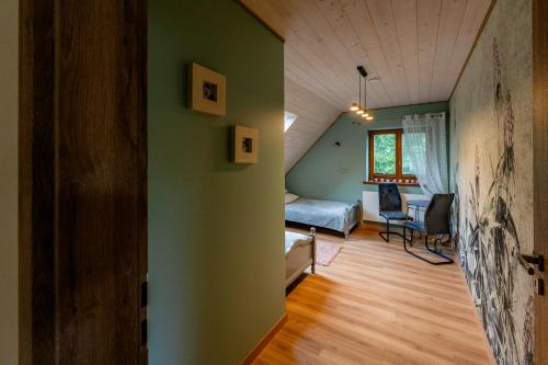 a room with a bed and a couch in a room at Rodzinne wczasy nad Czarną Hańczą 