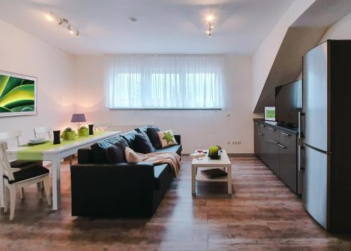 a living room with a couch and a table at Schubart Apartments in Bietigheim-Bissingen