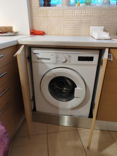a washing machine under a counter in a kitchen at Δροσια 1 in Nafplio
