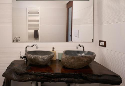 a bathroom with two sinks on a wooden table at @gatetothewild in Coreglia Ligure