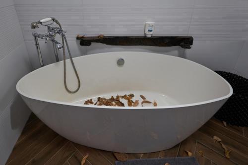 a white bath tub with some leaves in it at @gatetothewild in Coreglia Ligure